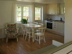 een keuken met een tafel en stoelen in een kamer bij 4 person holiday home in VIKBOLANDET in Arkösund