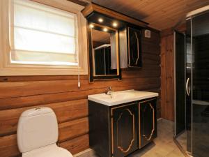 y baño con aseo, lavabo y espejo. en 8 person holiday home in F vang, en Tromsnes