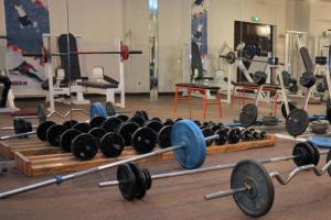 a gym with lots of dumbbells and other equipment at Hotel Jam Session in Les Deux Alpes