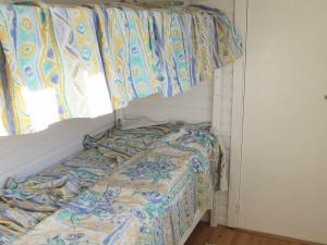 een bed in een kamer met een raam bij 4 person holiday home in Stege in Pollerup Kullegård