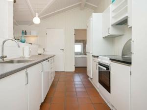 A kitchen or kitchenette at Inviting Holiday Home in Vejers Strand with Sauna