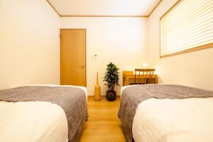 Postel nebo postele na pokoji v ubytování FUJI-AKATSUKI Enn