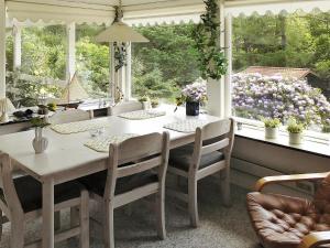 a dining room with a table and chairs and windows at 6 person holiday home in Nyk bing Sj in Højby