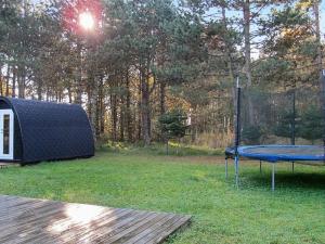 a tent and a picnic table in a yard with at 6 person holiday home in R dby in Rødby