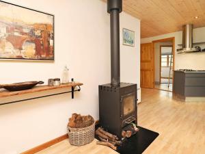 a wood stove in a living room with a counter at 6 person holiday home in L s in Læsø