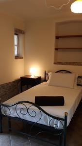 a bedroom with a bed with a lamp on a table at Agriturismo Cascina Binelli in Dogliani