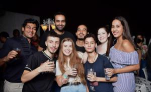 a group of people posing for a picture at a party at The Desire Hostel in New Delhi