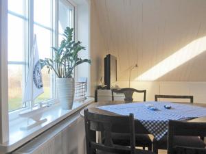 a dining room with a table and a window at 4 person holiday home in Romelanda in Romelanda
