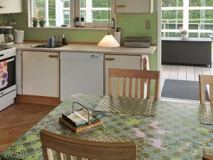 een keuken met een tafel met een boek erop bij 4 person holiday home in Hejls in Hejls