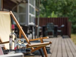butelka wina siedząca na krześle na patio w obiekcie 8 person holiday home in Hasle w mieście Hasle