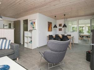 a living room with chairs and a dining room at Holiday home Henne IX in Henne Strand