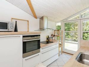 a kitchen with a sink and a stove top oven at Nature Retreat in albaek - By Traum Ferienwohnungen in Jerup