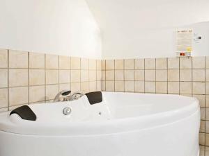 a white bath tub in a small bathroom at 4 person holiday home in V ggerl se in Marielyst