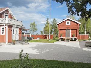 an old house and a red building next to a house at 4 person holiday home in RÄTTVIK-By Traum in Nedre Gärdsjö