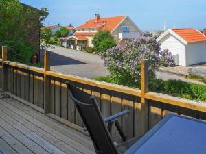 a deck with a chair and a table on a fence at 3 person holiday home in R nn ng in Rönnäng