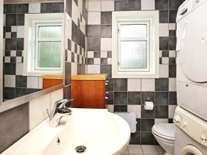 a bathroom with a sink and a toilet at 8 person holiday home in Fjerritslev-By Traum in Torup Strand +12 photos