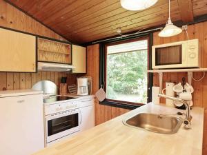 a kitchen with a sink and a counter top at 6 person holiday home in L s in Læsø