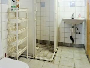 a small bathroom with a sink and a shower at Holiday Home Västra IV in Lysekil