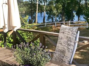 a bench with a sign and flowers next to a fence at 6 person holiday home in KYRKHULT in Kyrkhult