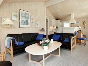 ブロックフスにある7 person holiday home in Blokhusのリビングルーム(ソファ、テーブル付)