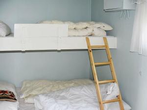 a room with a bunk bed with a ladder and a bunk bedoublethritisthritis at Holiday Home Hansbakken in Molde