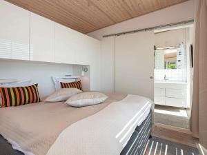 a bedroom with a large bed with white walls at 2 person holiday home in Slagelse in Slagelse