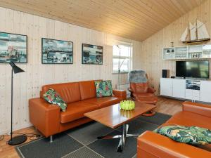 a living room with a couch and a table at 9 person holiday home in Hirtshals-By Traum in Hirtshals