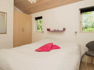 SjølundにあるHoliday home Sjølundのベッドルーム1室(赤い枕付きのベッド1台付)