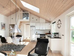 a kitchen and living room with a vaulted ceiling at 6 person holiday home in Karreb ksminde in Karrebæksminde