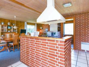 cocina y comedor con pared de ladrillo en 6 person holiday home in Bindslev, en Bindslev