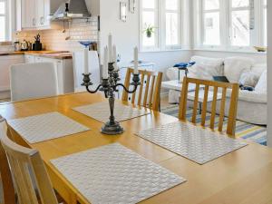 einen Esstisch mit 3 Kerzen darüber in der Unterkunft 5 person holiday home in DYR N in Stora Dyrön