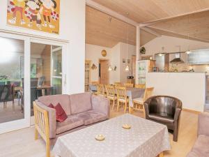 a living room with a couch and a table at 6 person holiday home in Ringk bing in Ringkøbing