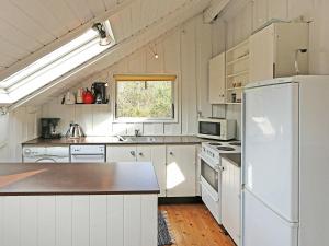 a kitchen with white appliances and a white refrigerator at 6 person holiday home in R dby in Rødby