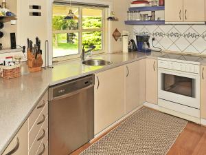 a kitchen with a sink and a dishwasher at 8 person holiday home in Oksb l in Øster Vrøgum