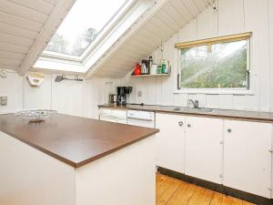 a kitchen with a counter top and a window at 6 person holiday home in R dby in Rødby