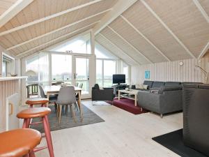a living room with a couch and a table at Three-Bedroom Holiday home in Nykøbing Sj 7 in Lumsås