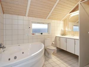 a bathroom with a tub and a toilet and a window at 6 person holiday home in Nykøbing Sj-By Traum in Lumsås +17 photos