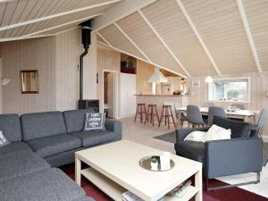 a living room with a couch and a table at Three-Bedroom Holiday home in Nykøbing Sj 7 in Lumsås