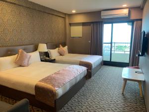 Postel nebo postele na pokoji v ubytování Chi Shing Hai Hotel
