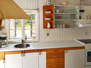 a kitchen with a sink and a window at 6 person holiday home in R dby in Rødby