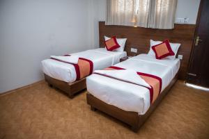 Łóżko lub łóżka w pokoju w obiekcie Hotel Himalayan Vacation