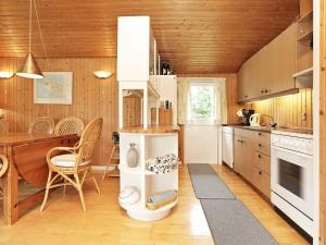 a kitchen and dining room with a table and chairs at Holiday Home Filosofstræde in Dannemare