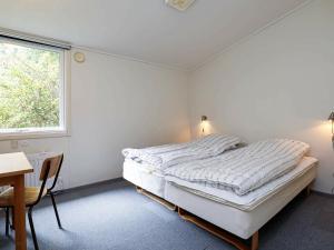 a bedroom with a bed and a desk and a window at Spacious Retreat by Limfjorden - By Traum Ferienwohnungen in Sillerslev +94 photos