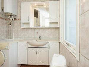 a bathroom with a sink and a toilet and a mirror at 8 person holiday home in B rkop in Egeskov