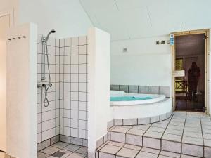 a large bathroom with a tub and a shower at 12 person holiday home in Aakirkeby in Vester Sømarken