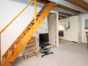 une chambre avec un escalier, une télévision et une cuisine dans l'établissement 5 person holiday home in Ebeltoft, à Øksenmølle