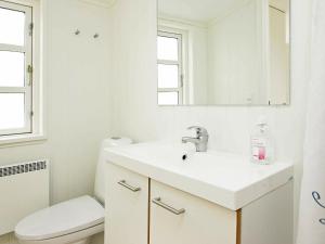 a white bathroom with a sink and a toilet at 4 person holiday home in Skagen-By Traum in Skagen