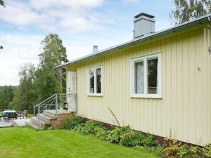 una casa gialla con portico e patio di Holiday home BORÅS a Borås