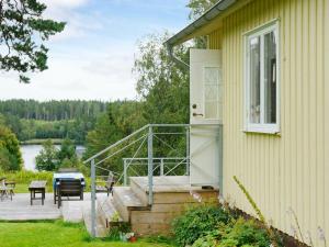 a porch of a house with a patio and a table at Holiday home BORÅS in Borås