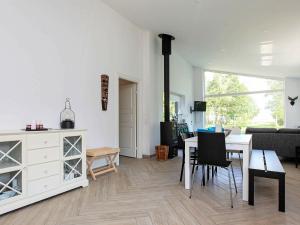 a living room with a table and chairs and a couch at 7 person holiday home in Jægerspris-By Traum in Jægerspris +14 photos